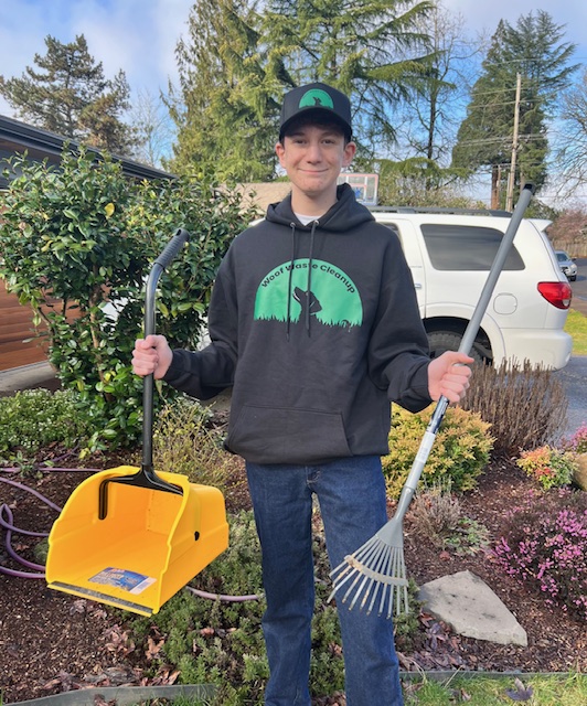 Woof Waste Cleanup crew member in a backyard